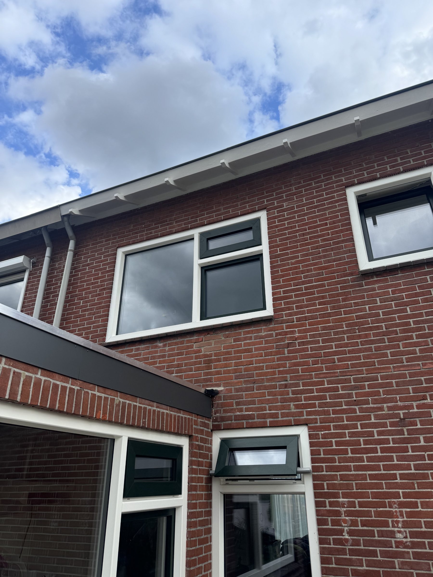 De vernieuwde kozijnen aan de achterzijde, op de verdieping en bij de uitbouw.